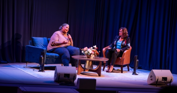 Roxane Gay and Becky R. Petitt sit on chairs across from each other on a stage