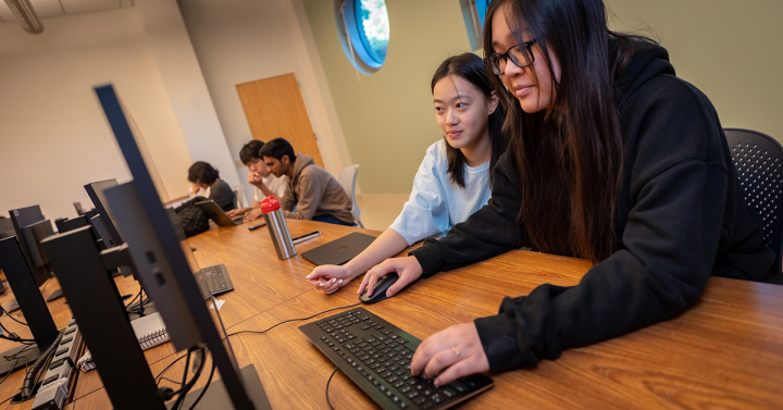 Picture of two students at a computer 