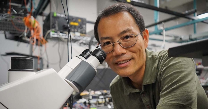 Scientist in front of microscope