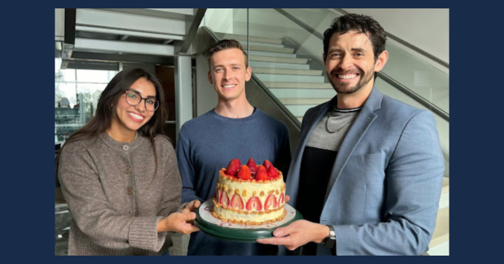 Megan Chavez, Brandon Vogt and Brian Aguado holding a celebratory cake