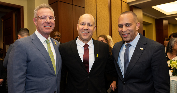 Rep. Scott Peters, Dr. Jim Brewer and House Minority Leader Hakeem Jeffries stand together at reception