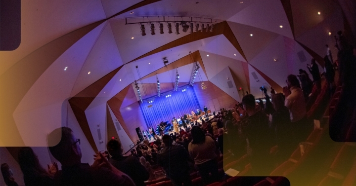 Audience on their feet listening to a concert in Conrad Prebys Concert Hall