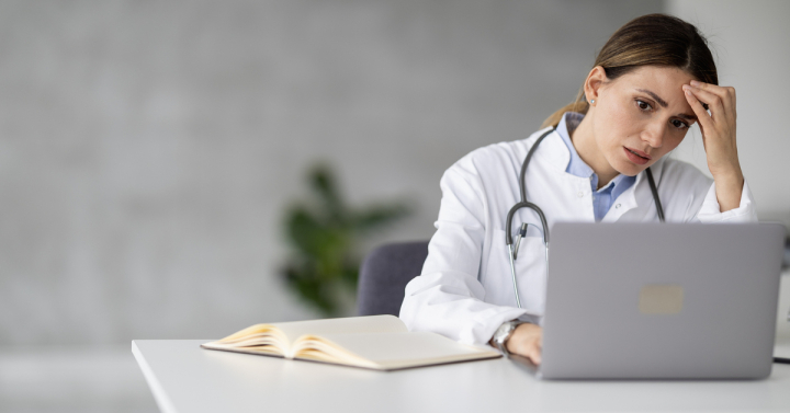 Portrait of female doctor in her office. People,healthcare and medical concept.She is having headache after hard day on work.