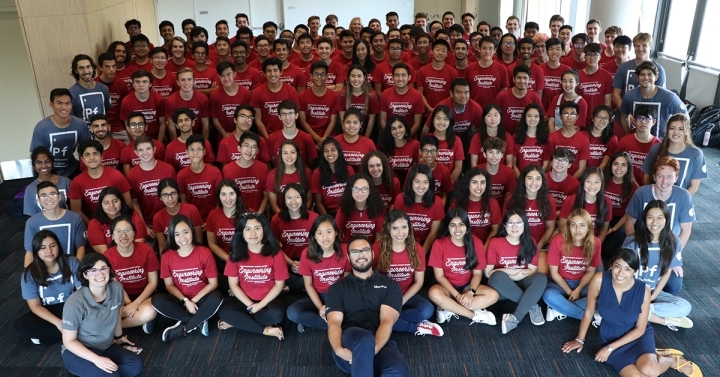 A group of students and staff wearing Summer Engineering Institute shirts. 