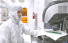 Video: Picture of a researcher at a microscope in a clean room suit