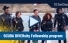 Video: A group of people dressed in scuba gear stand on a pier.