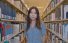 Video: WongAvery Visiting Scholar Claire Ping standing in the book stacks at Geisel Library.