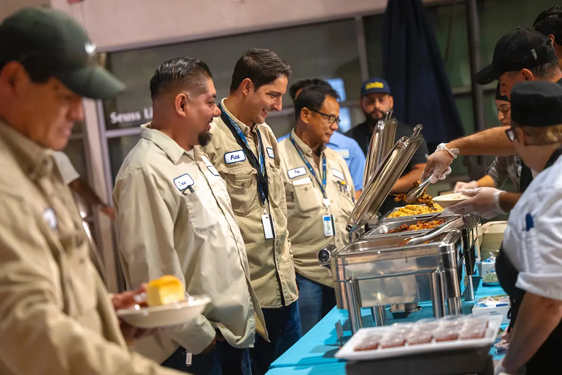 Staff enjoy the Hawaiian barbeque menu.