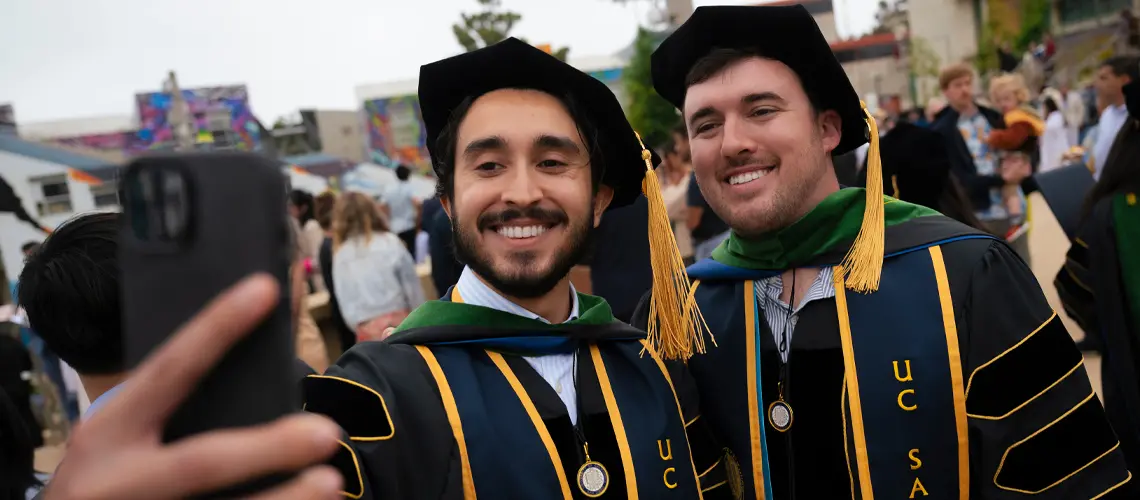 Two male medical school graduates taking a selfie