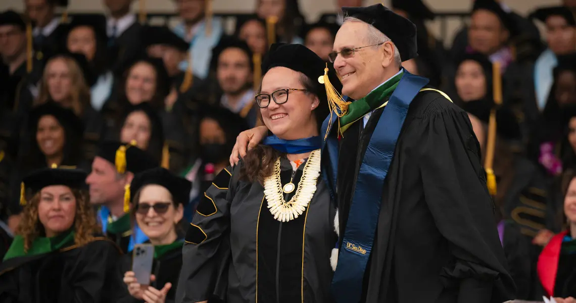 Female medical school graduate posing with faculty mentor