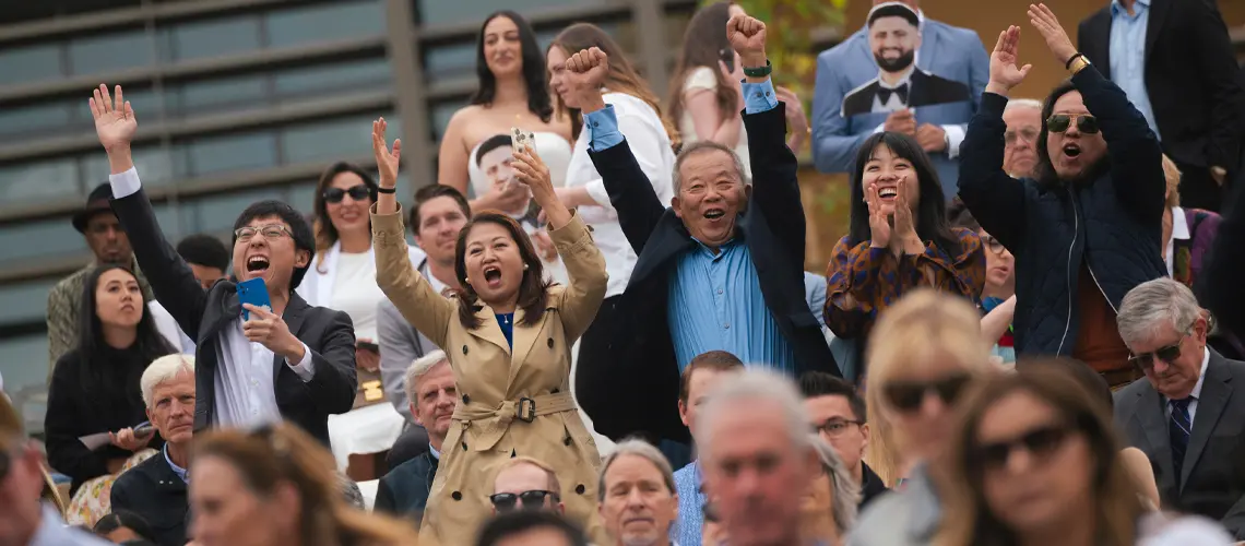 Crowd picture of cheering family members at School of Medicine commencement ceremony