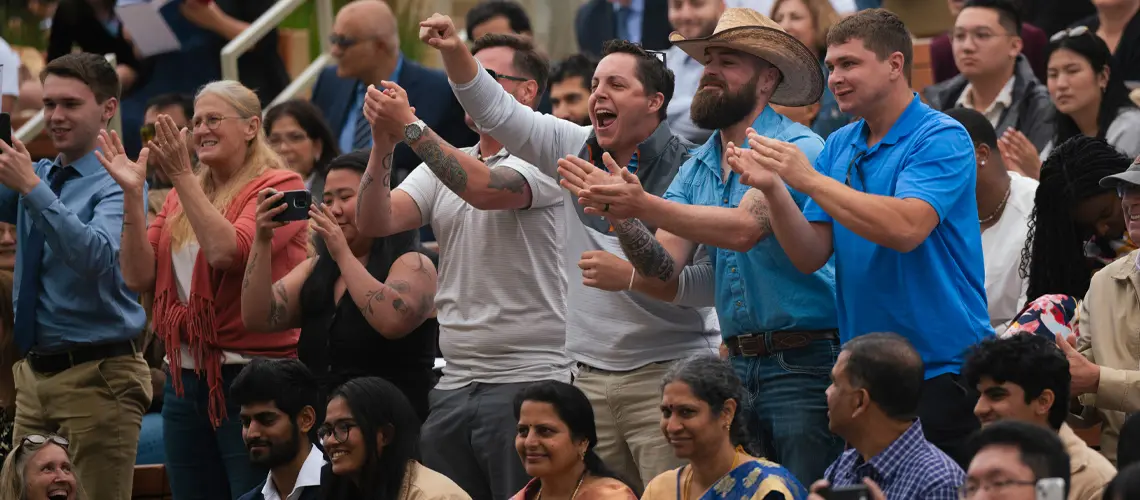 Crowd picture of cheering family members at School of Medicine commencement ceremony