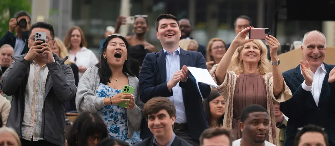 Crowd picture of cheering family members at School of Medicine commencement ceremony