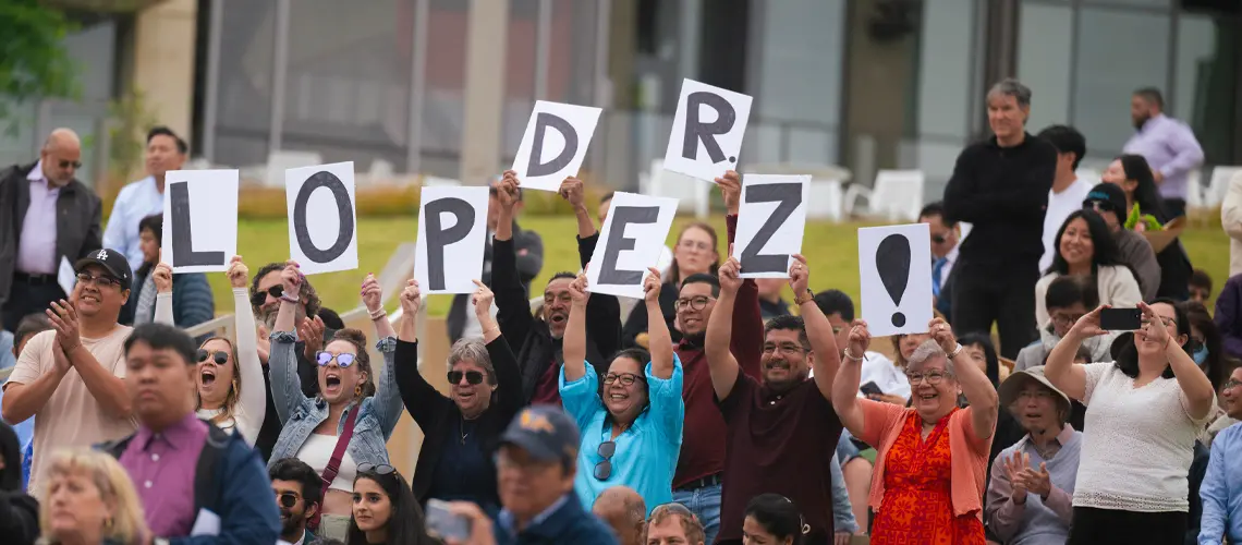 Crowd picture of cheering family members at School of Medicine commencement ceremony