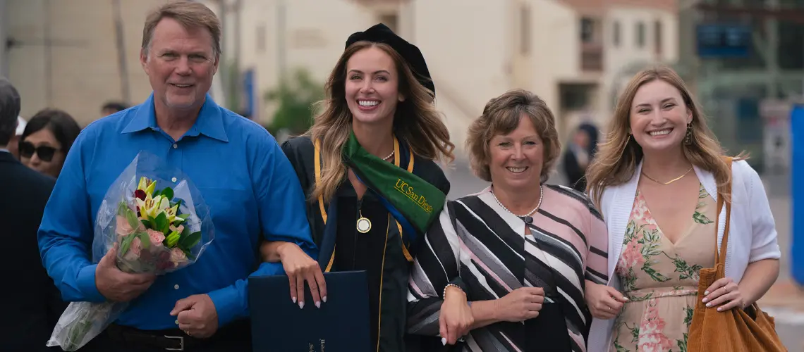 Female School of Medicine graduate posing with her family