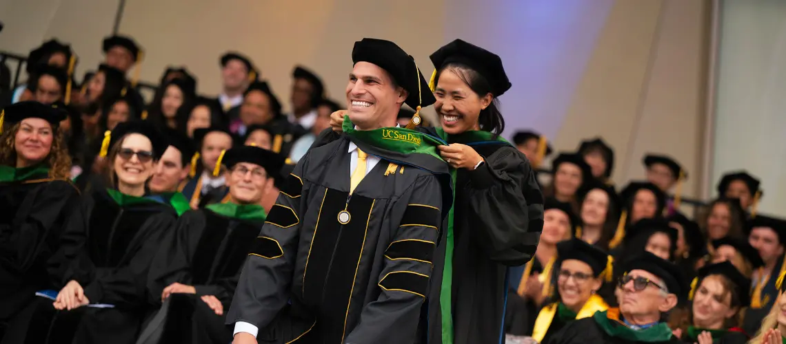 Medical student being hooded at commencement ceremony