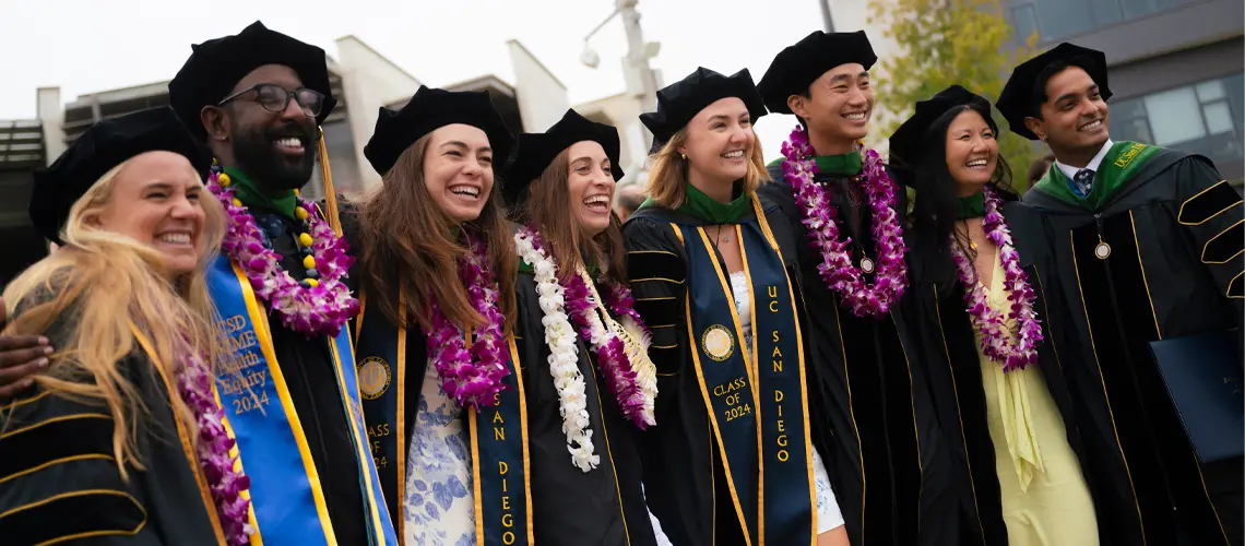 Group of medical school graduates posing and smiling