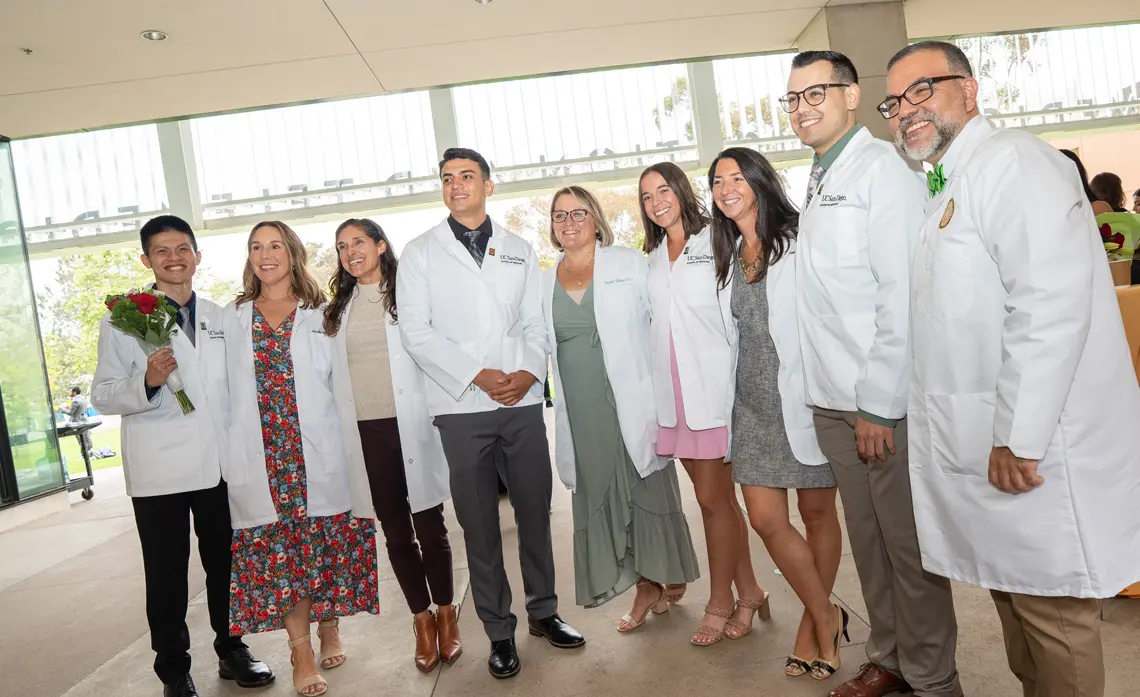 PA program faculty and staff pose with new PA students at their White Coat Ceremony