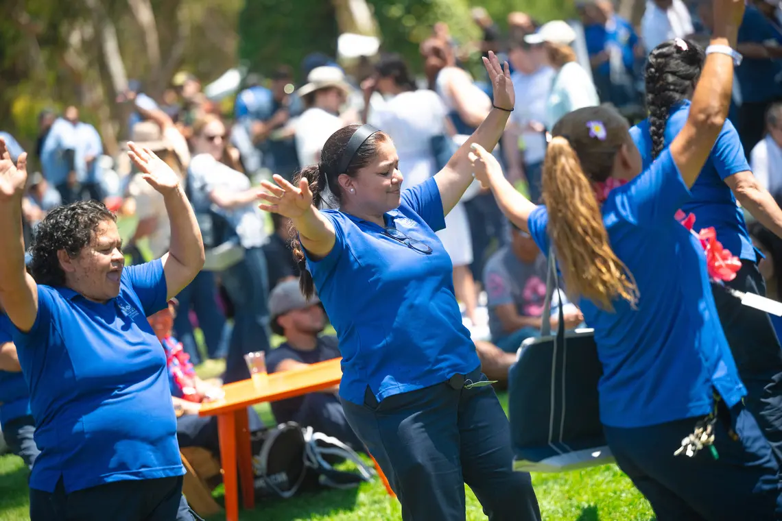 Staff members dancing on Sun God Lawn