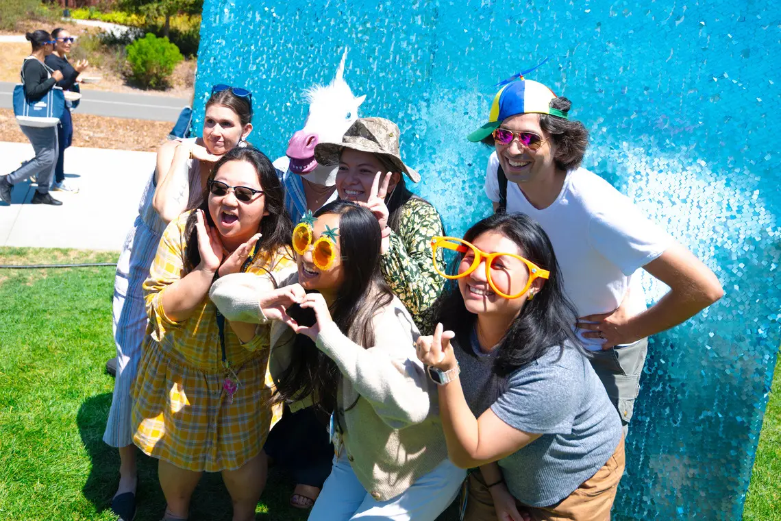 Staff members pose in a photo booth