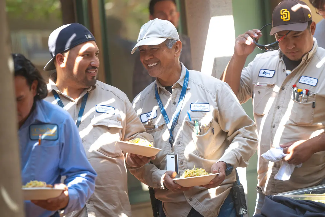 Staff members in line to receive their lunch at the celebration.