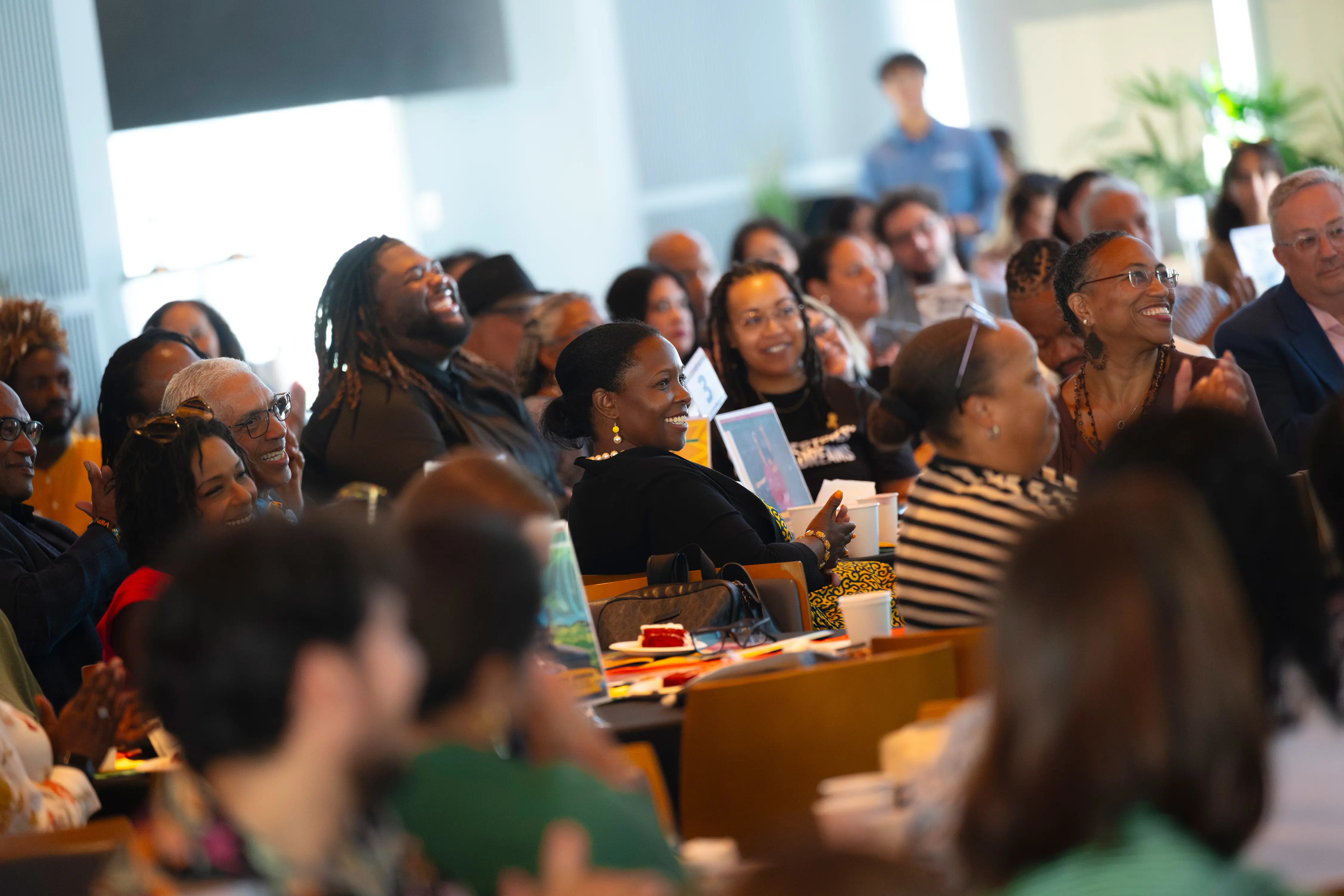 People smiling while sitting at a table