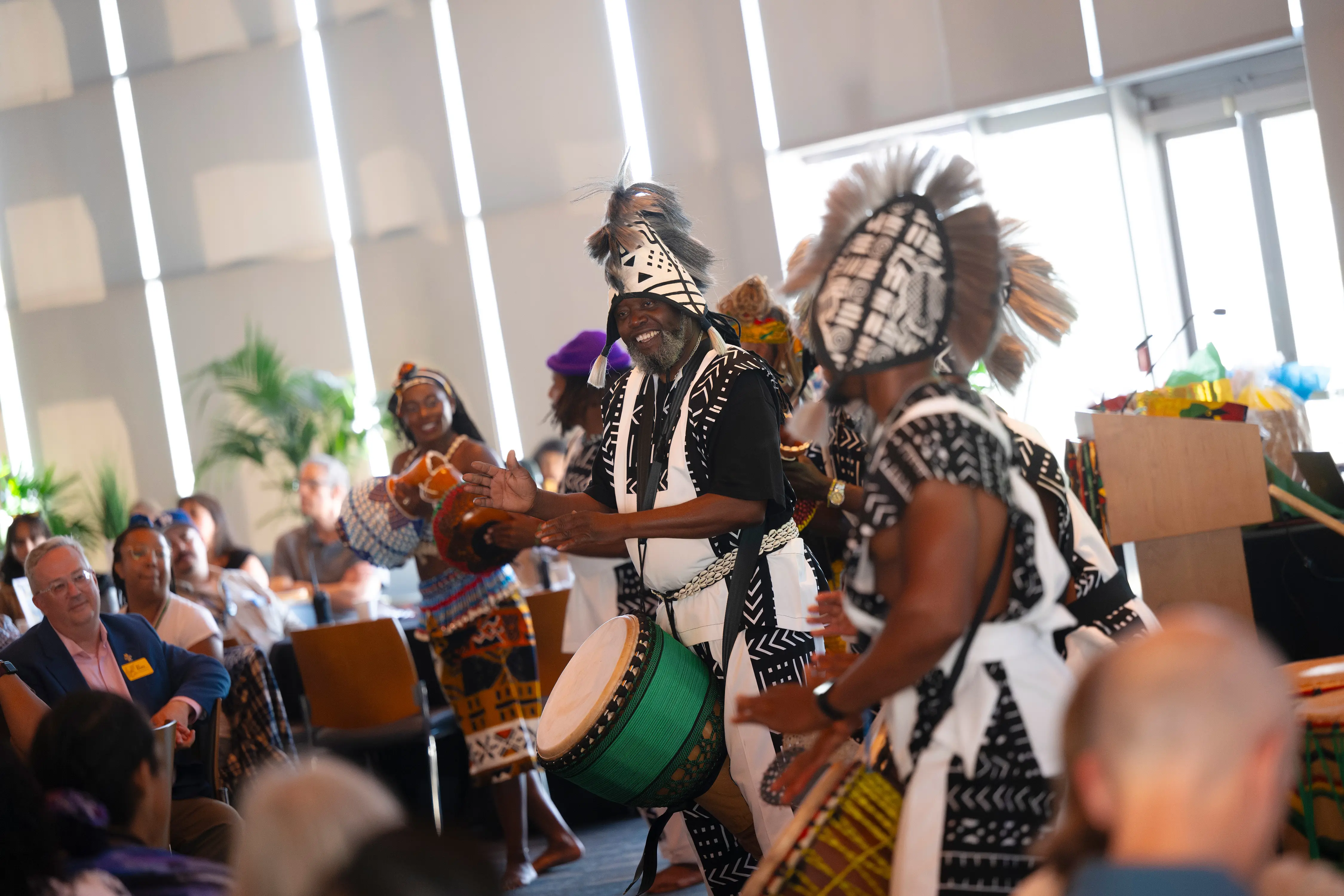People drumming in traditional West African attire