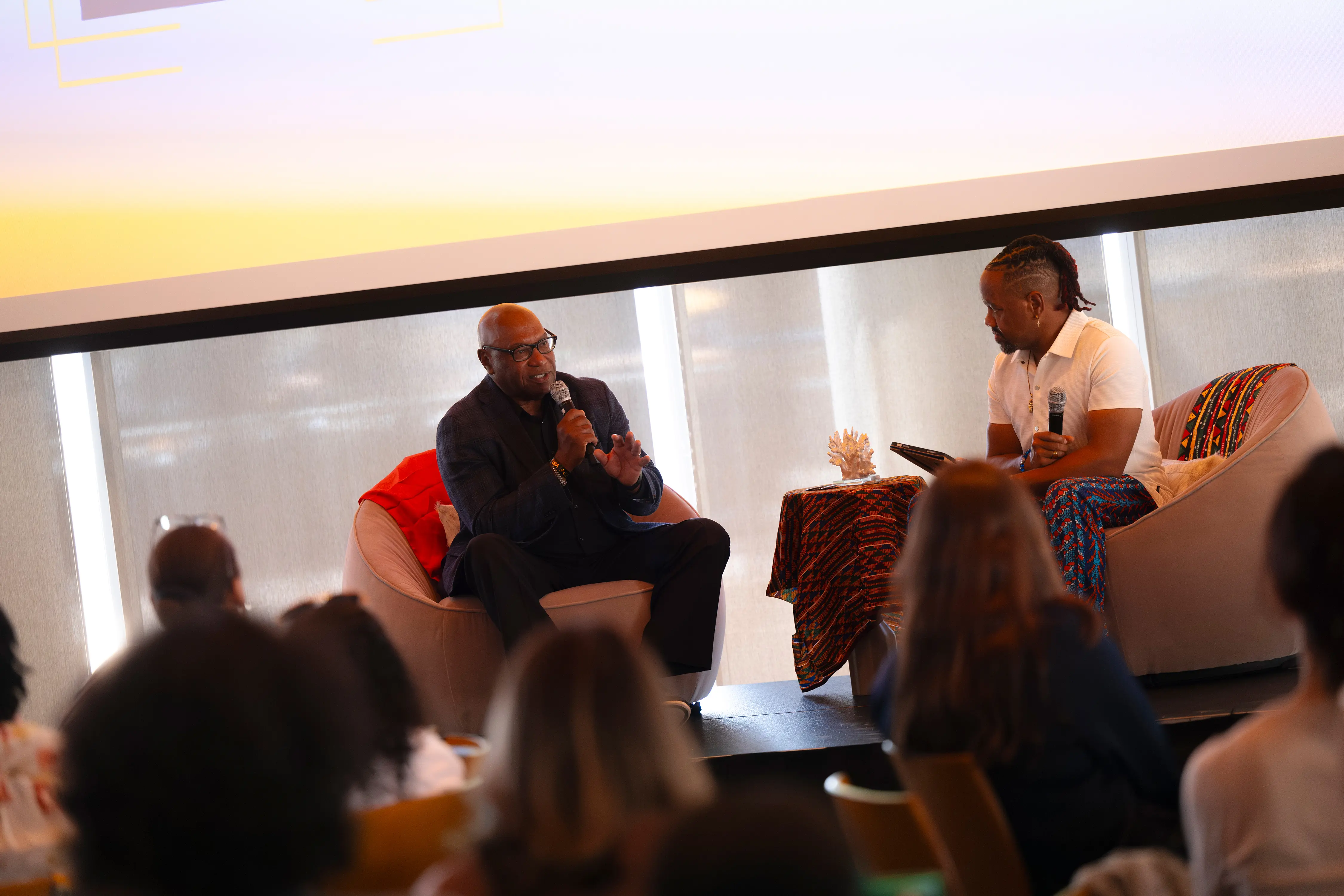Two people sitting down speaking