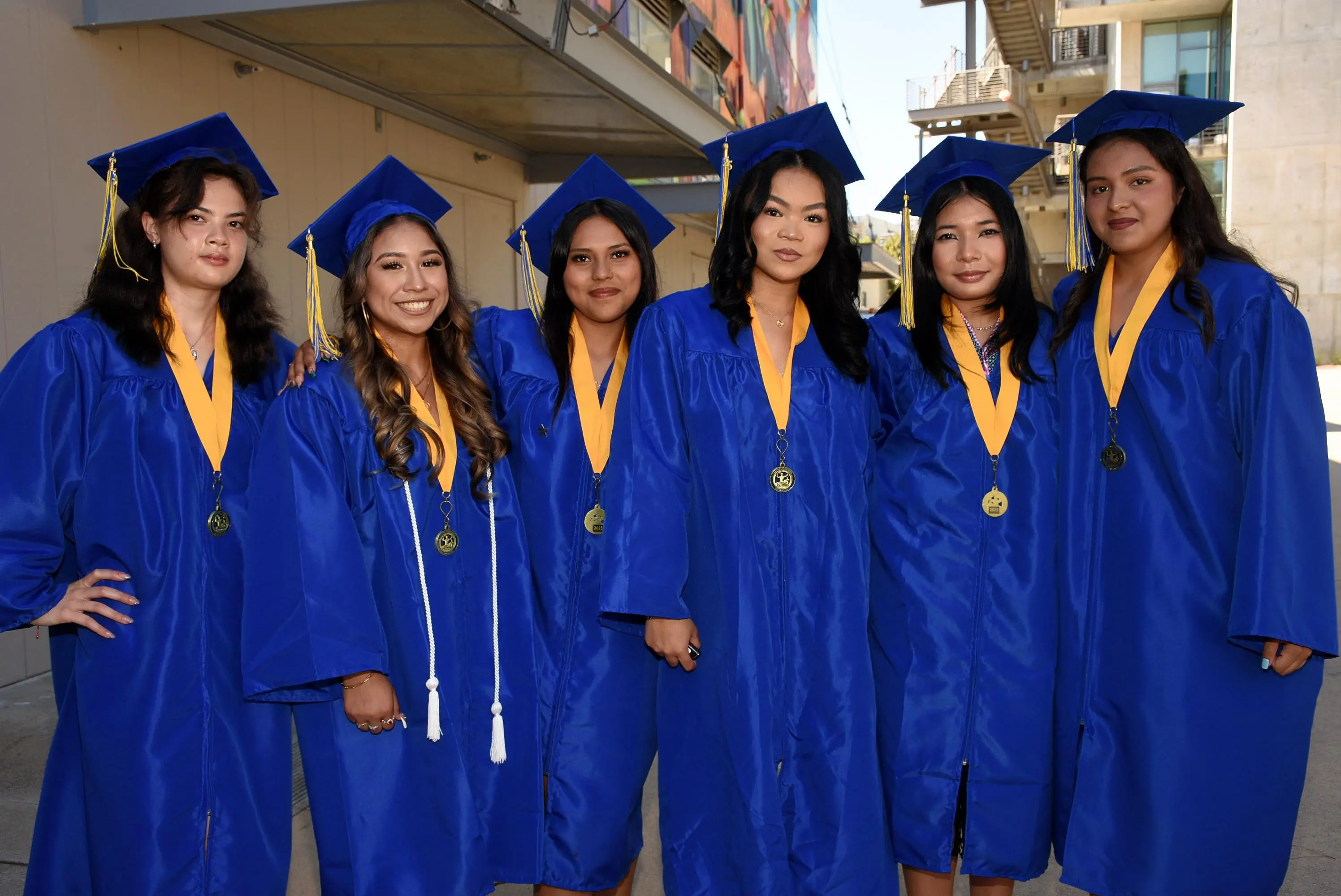 six students smile at camera