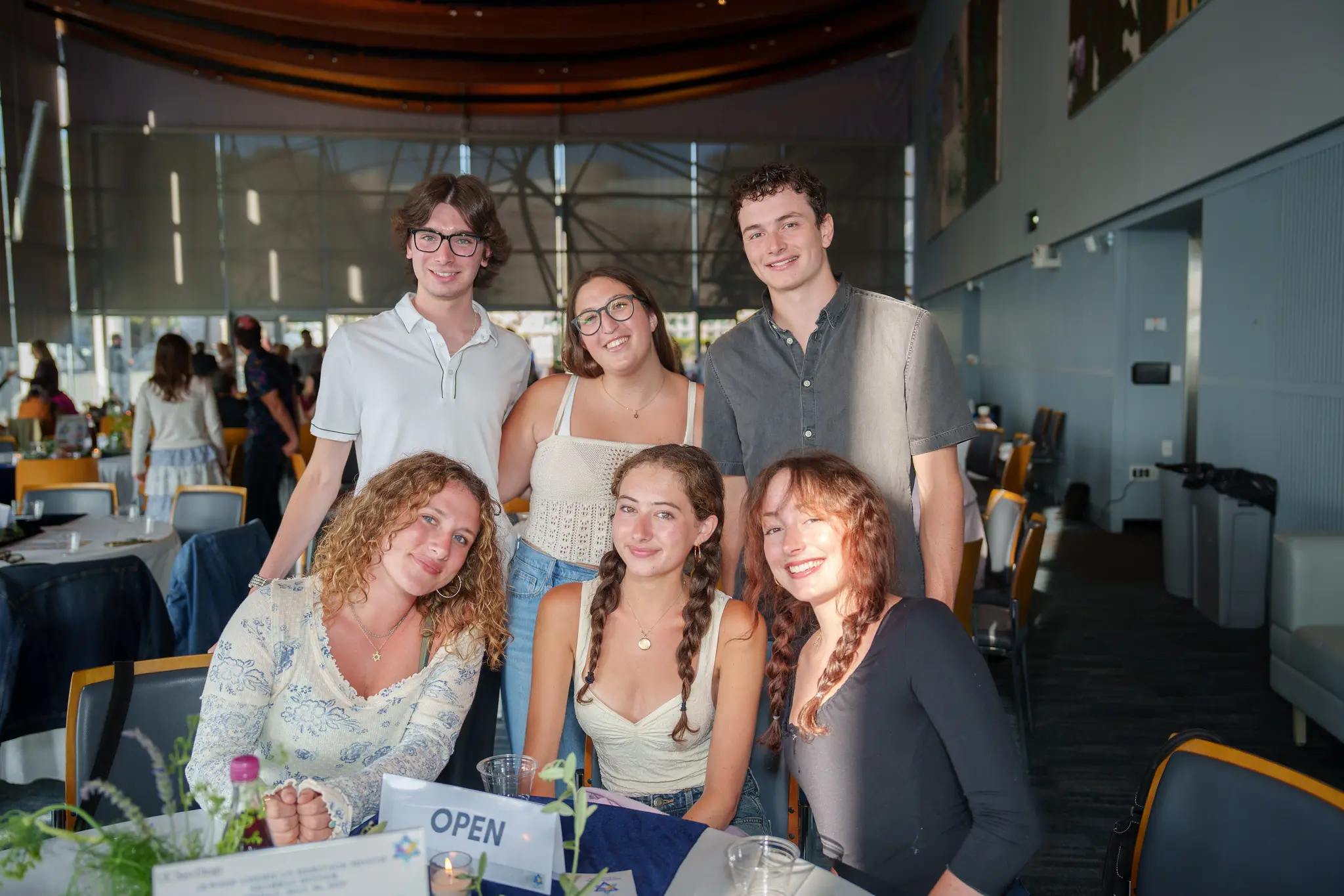 Six people smile at the camera