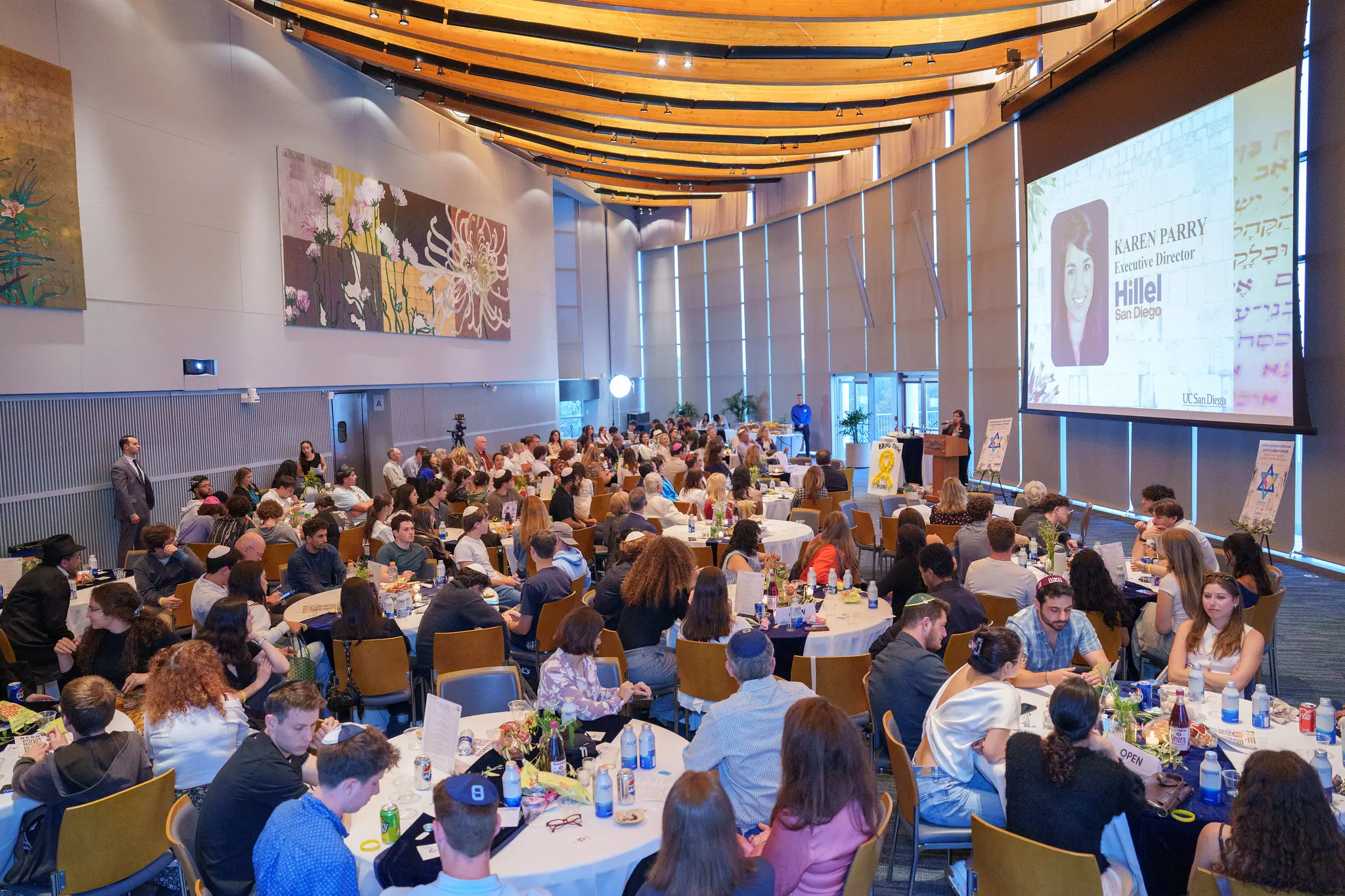 Wide angle shot of a full celebration hall with tables