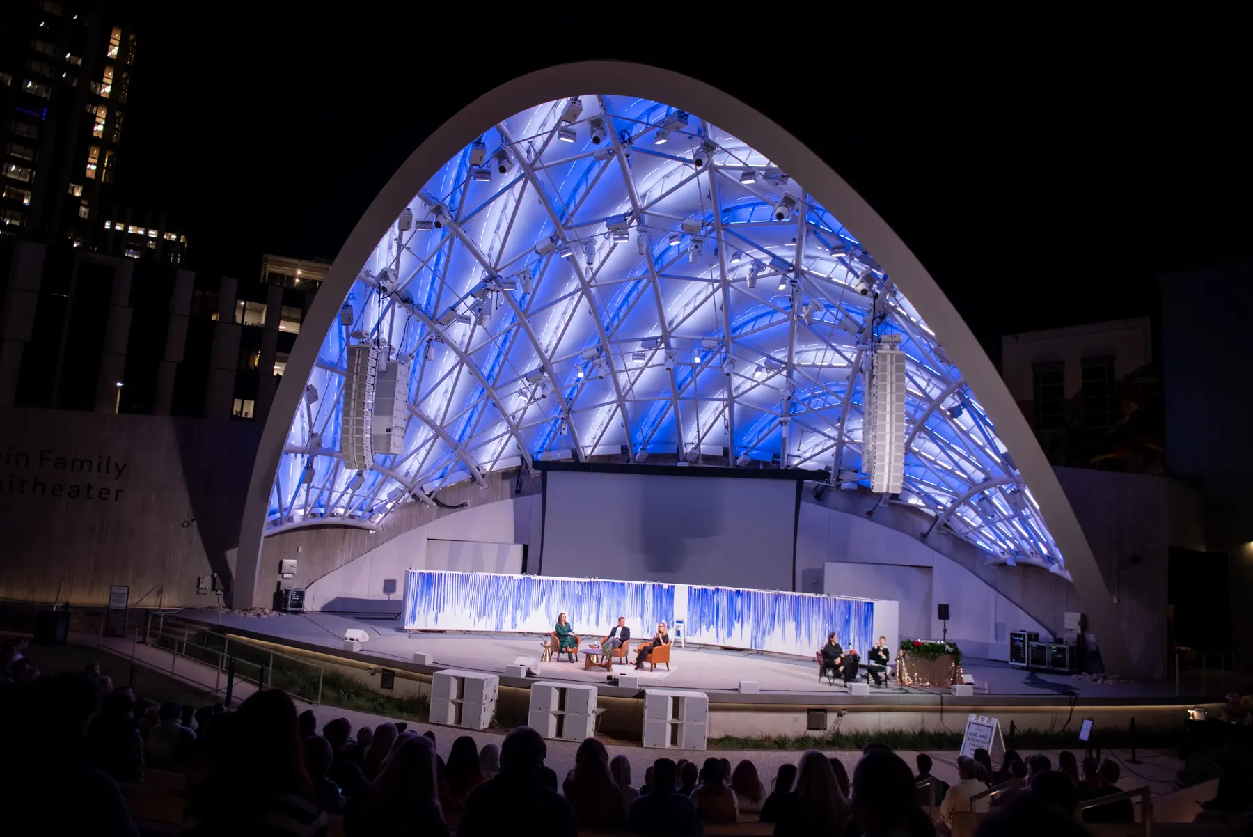 Wide angle shot of Epstein Family Amphitheater lit in blue