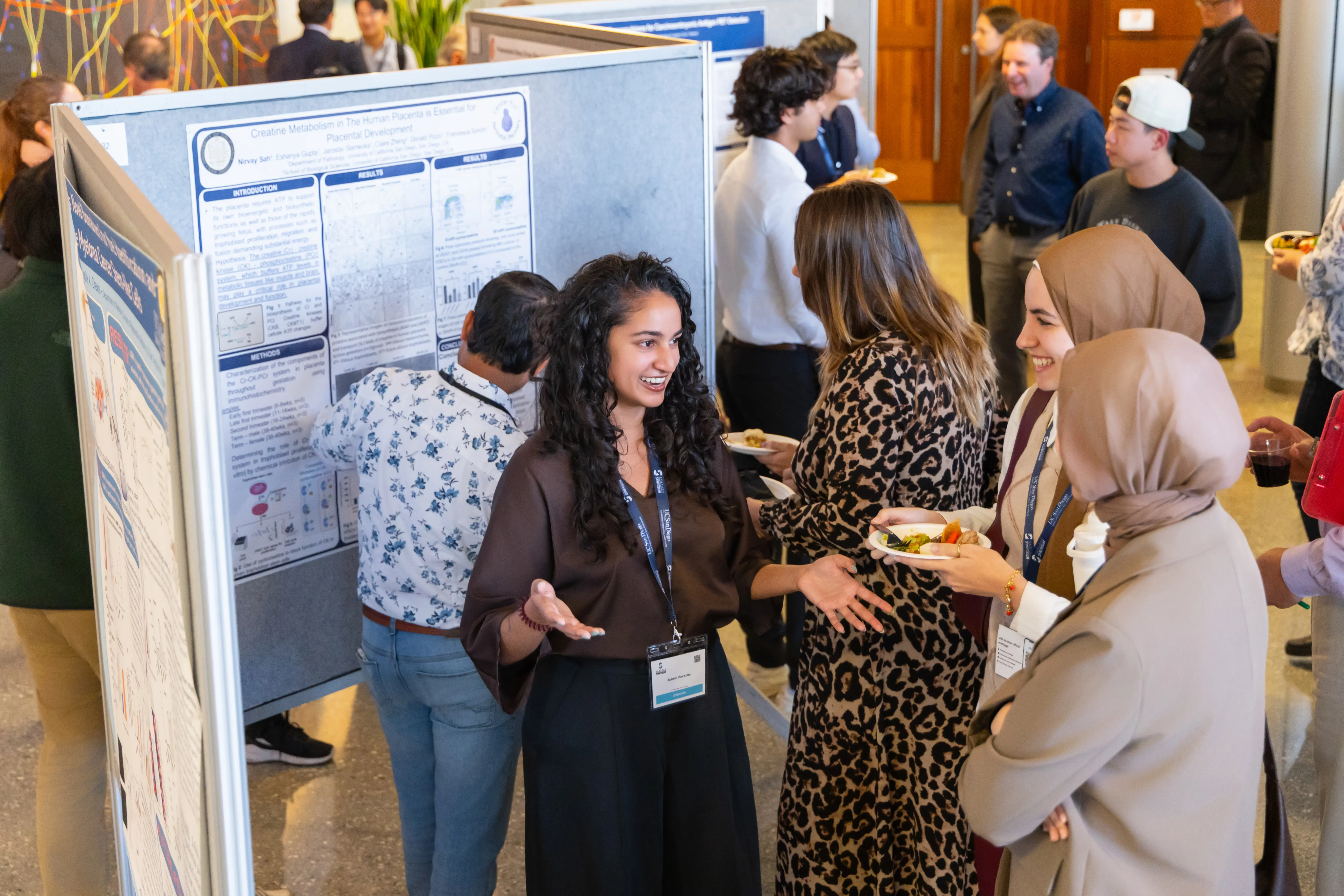 Female presents display board and speaks to guests