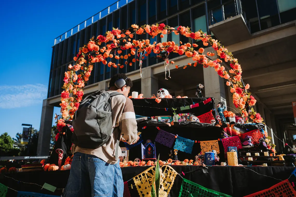 Student adding item to altar