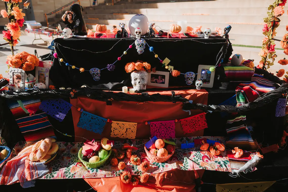 A view of the community altar, showing food, photos and more