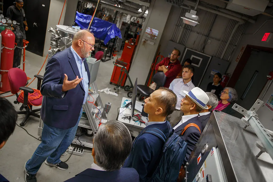 Professor talking to a group of visitors. 