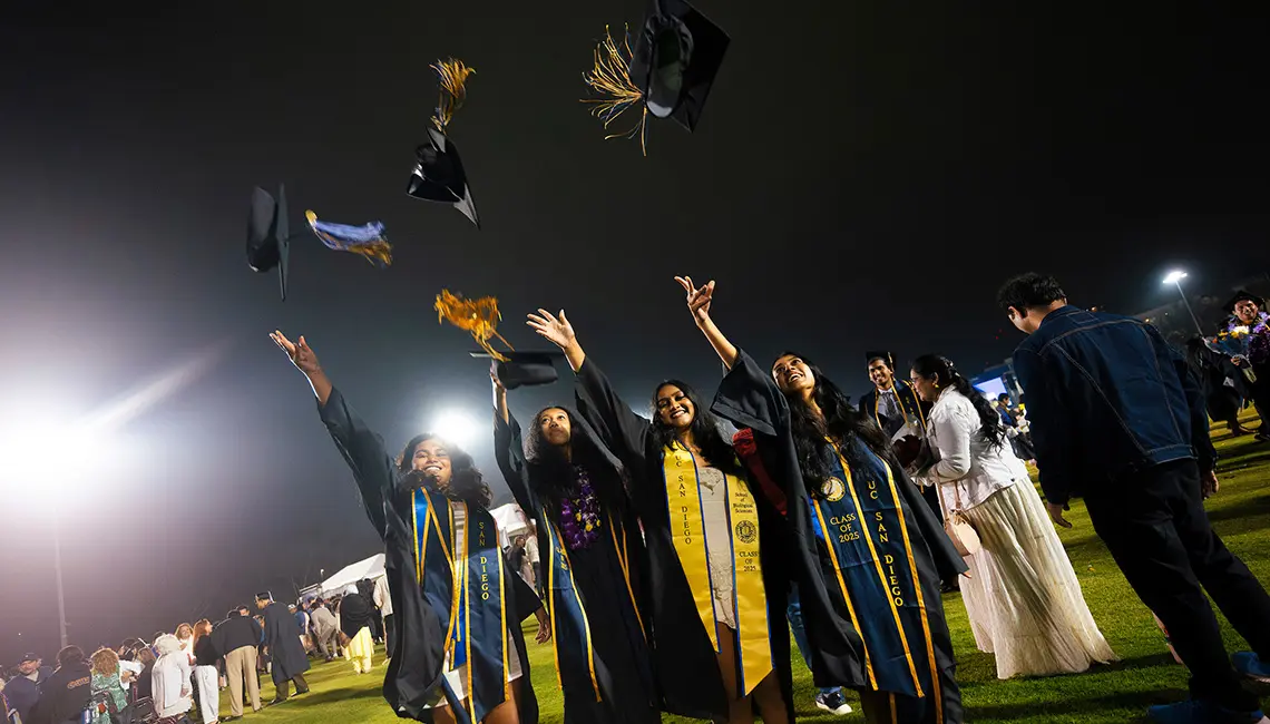 Four grads toss caps