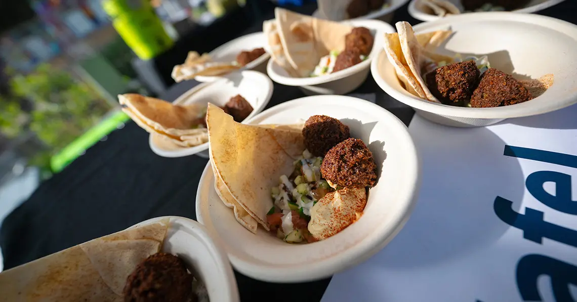 Bowls of falafel and pita on table