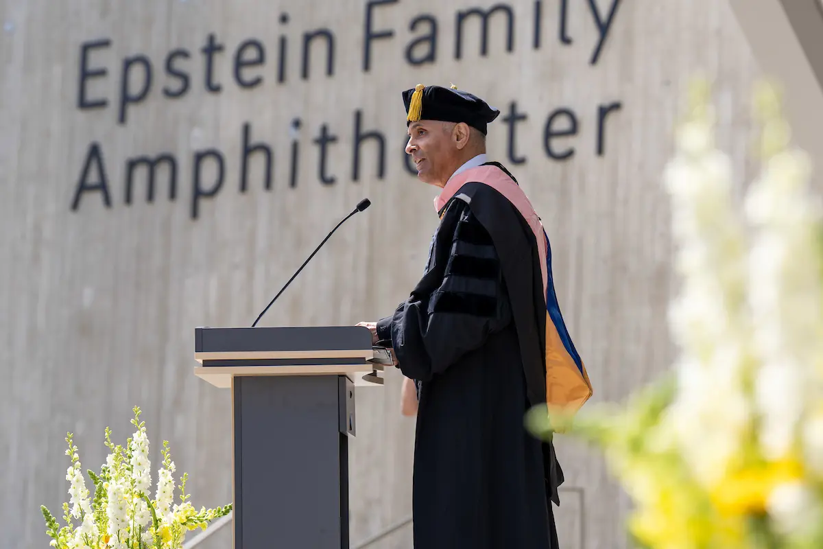 Commencement speaker Tomás Aragón, M.D., Dr.P.H., at the commencement podium in graduation regalia giving his keynote address.