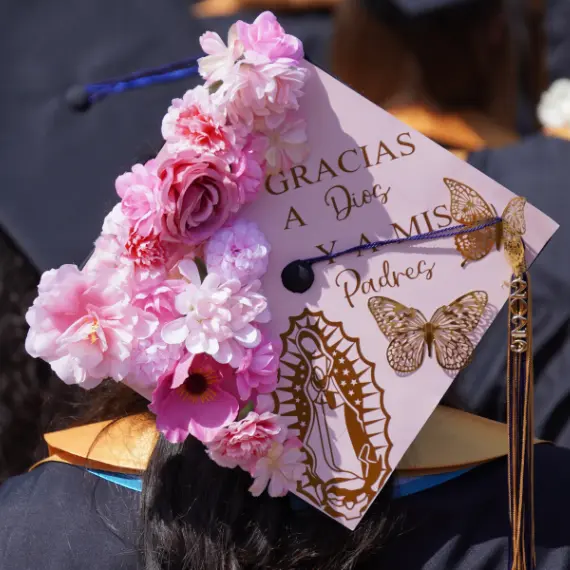 Photo of a pink graduation cap that reads: