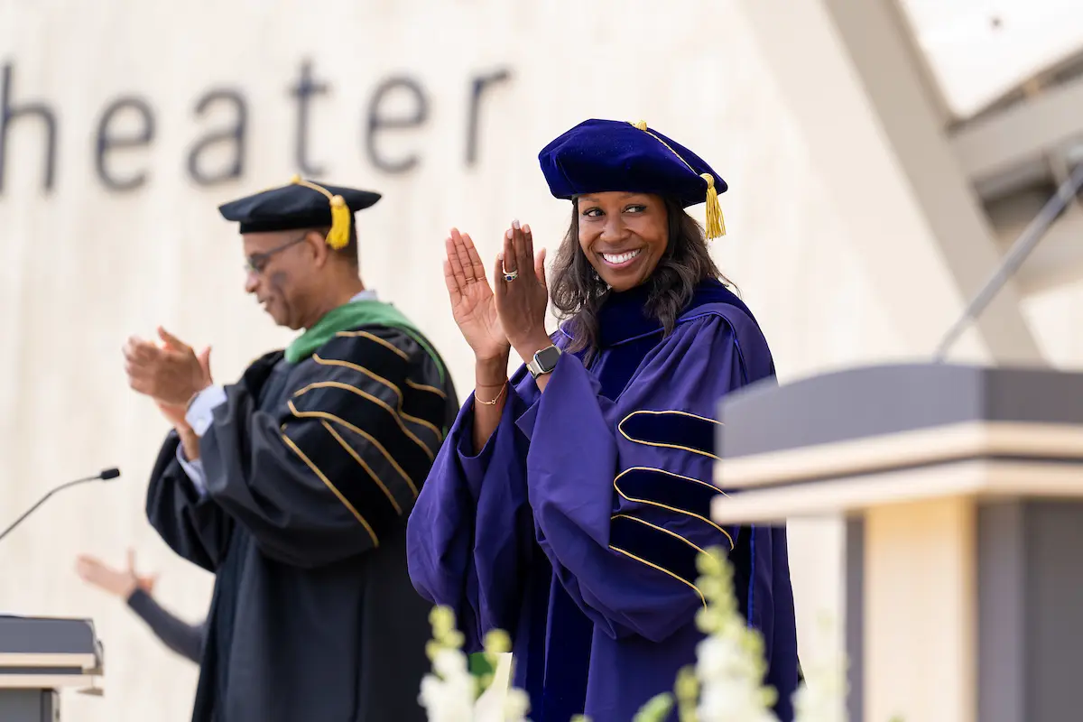Cheryl A.M. Anderson, Ph.D., M.P.H, professor, founding dean of the Herbert Wertheim School of Public Health and Human Longevity Science and inaugural Hood Family Endowed Dean’s Chair in Public Health standing at the podium in graduation regalia.