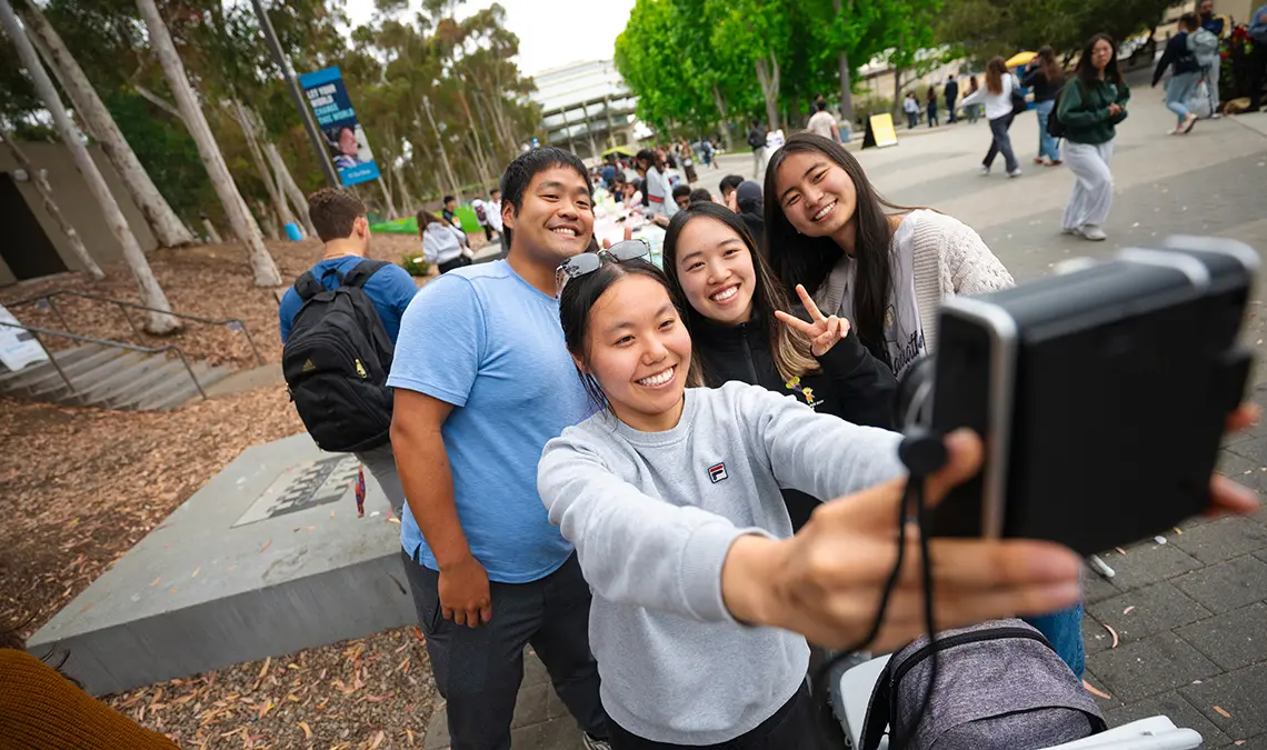 Four students take a Polaroid selfie