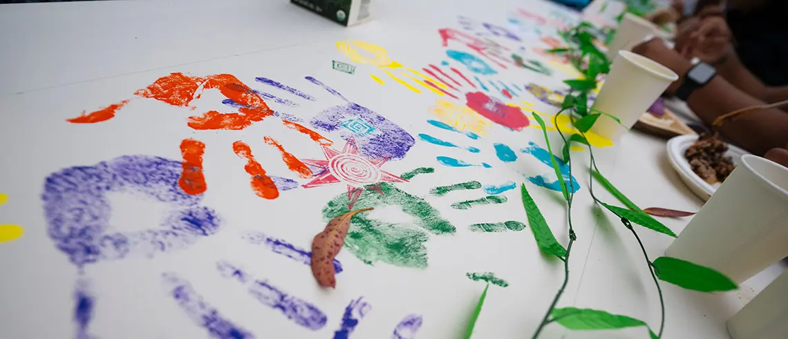 Tablecloth decorated with colorful handprints and designs