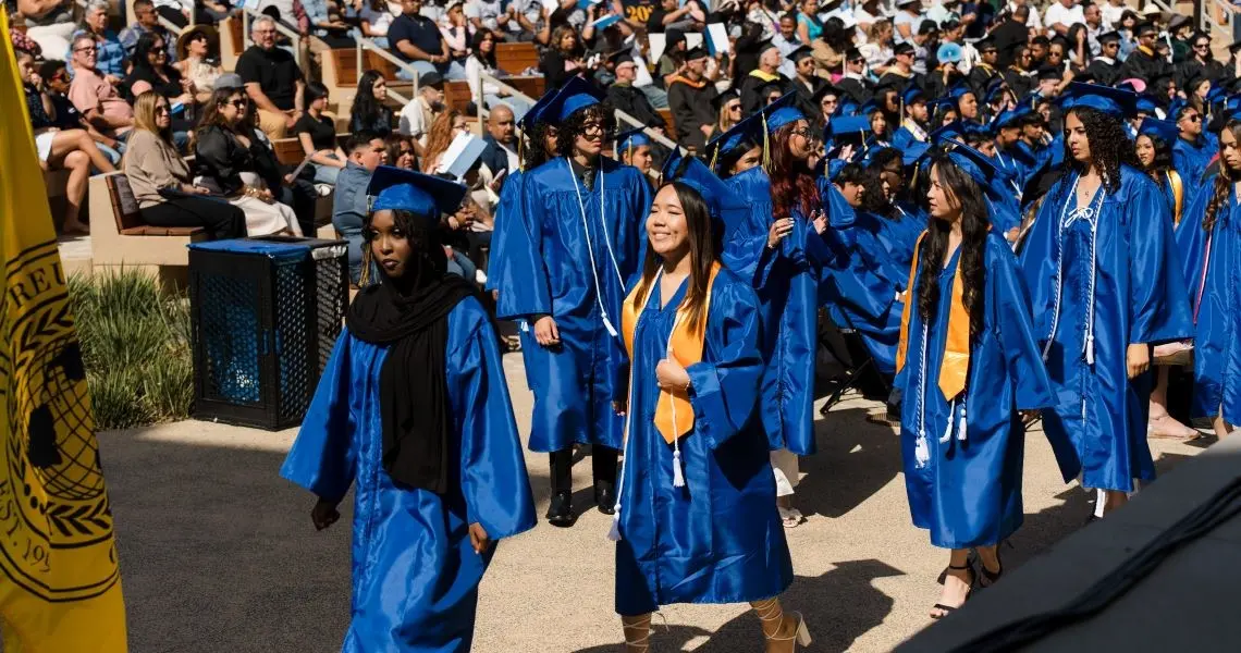 Students walking to their seats in graduation attire