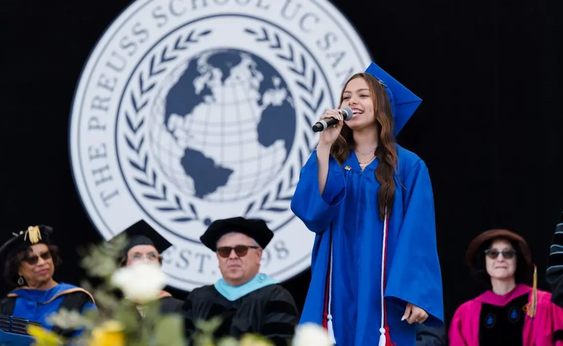 A graduate speaking into the microphone