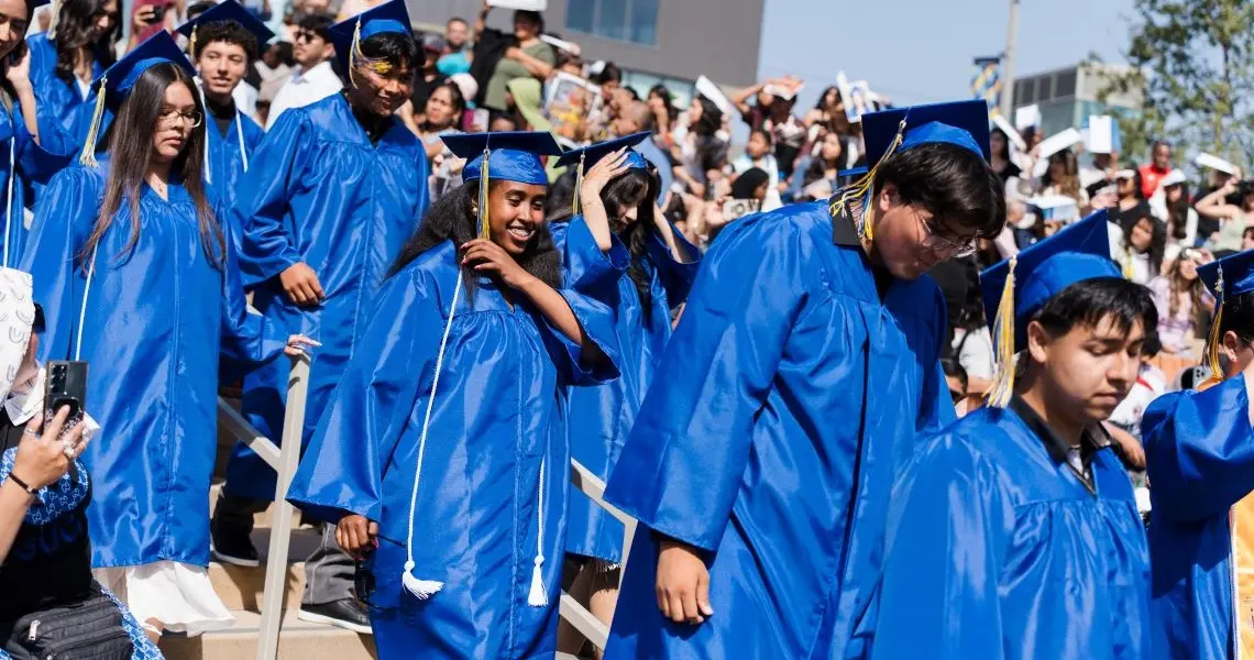 Students walking down to their seats in graduation attire