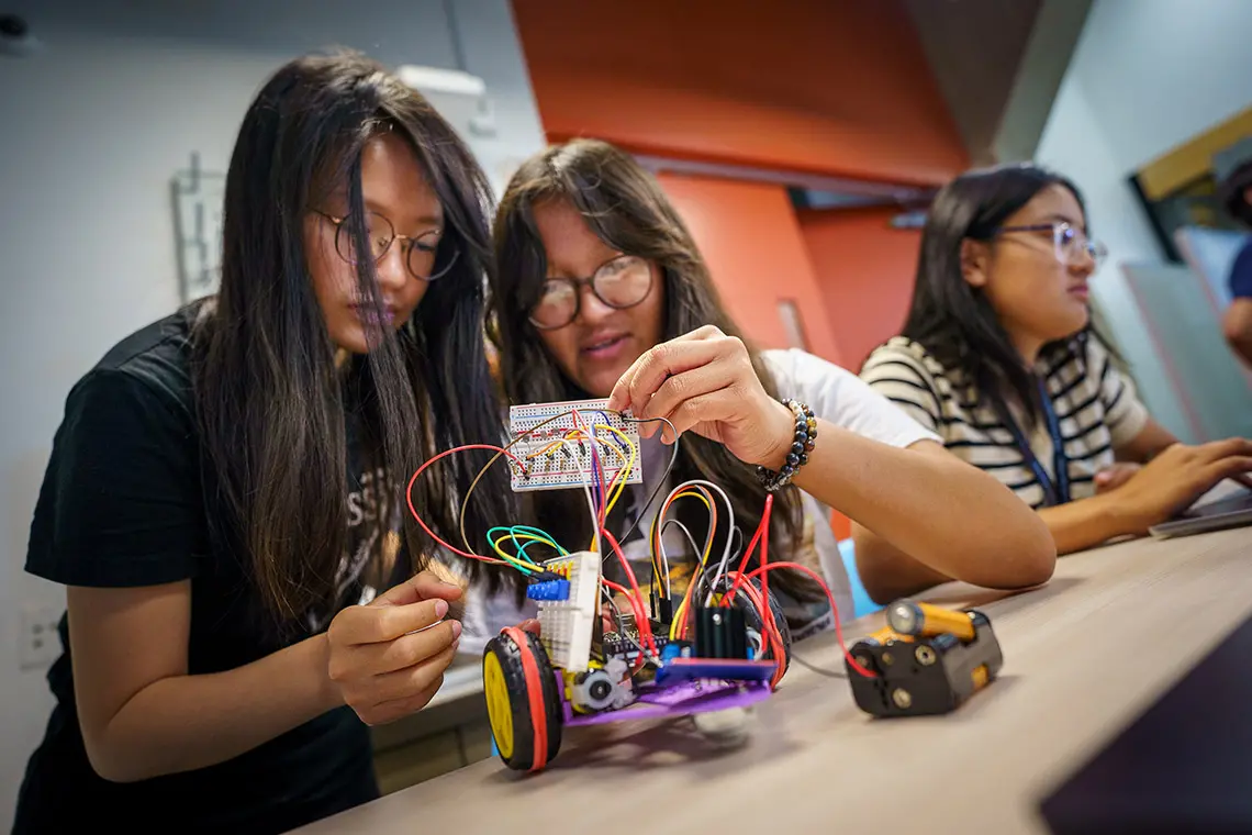 Students build a robot together.