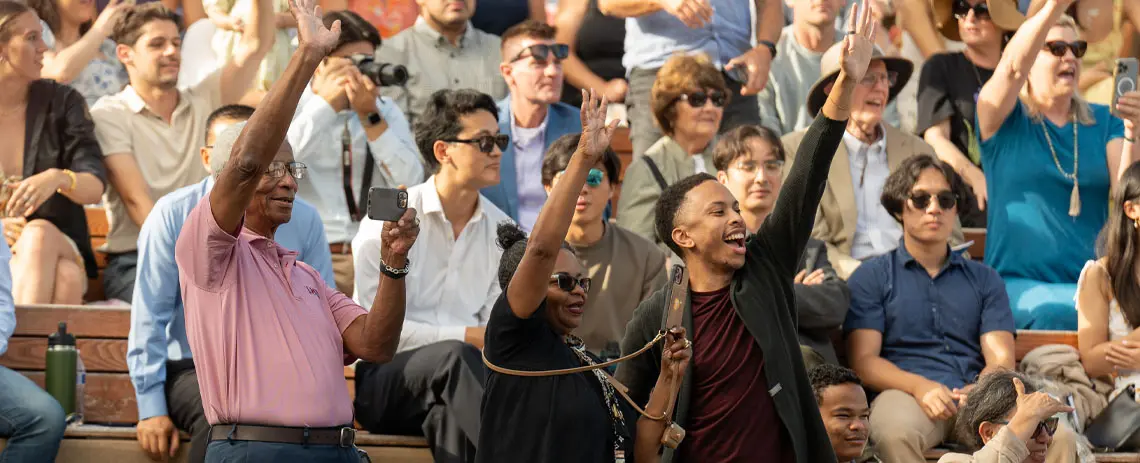 Cheering family members in the crowd at Epstein Family Amphitheater