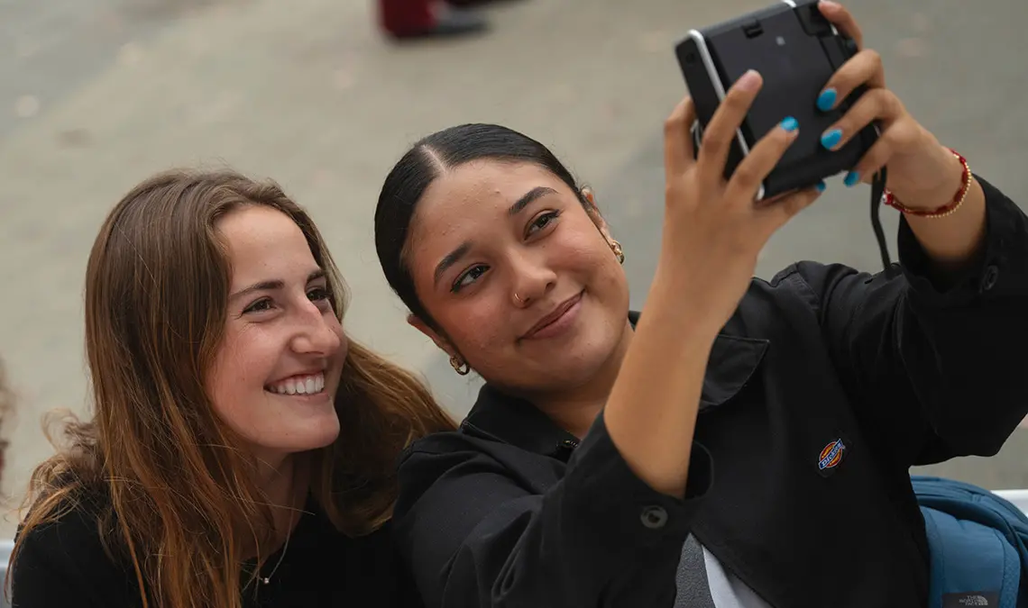 Two students take selfie with Polaroid