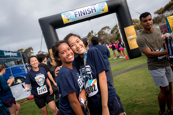 Two students smile after completing the annual Triton 5K race